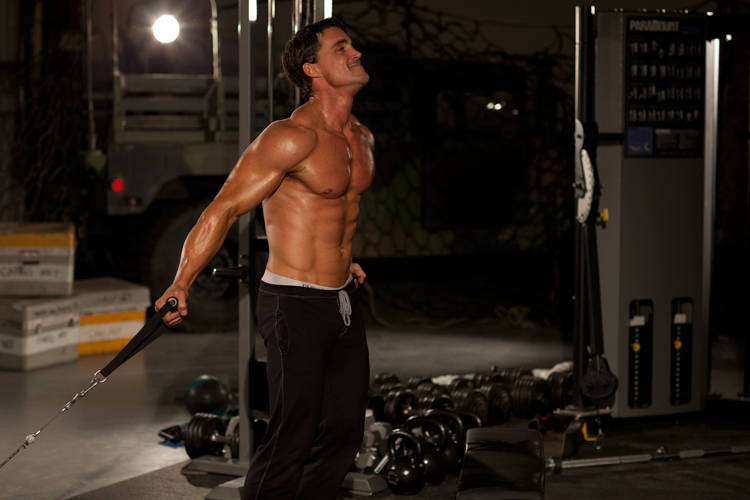 Demonstration of Low Cable Crossover exercise showing proper form and technique
