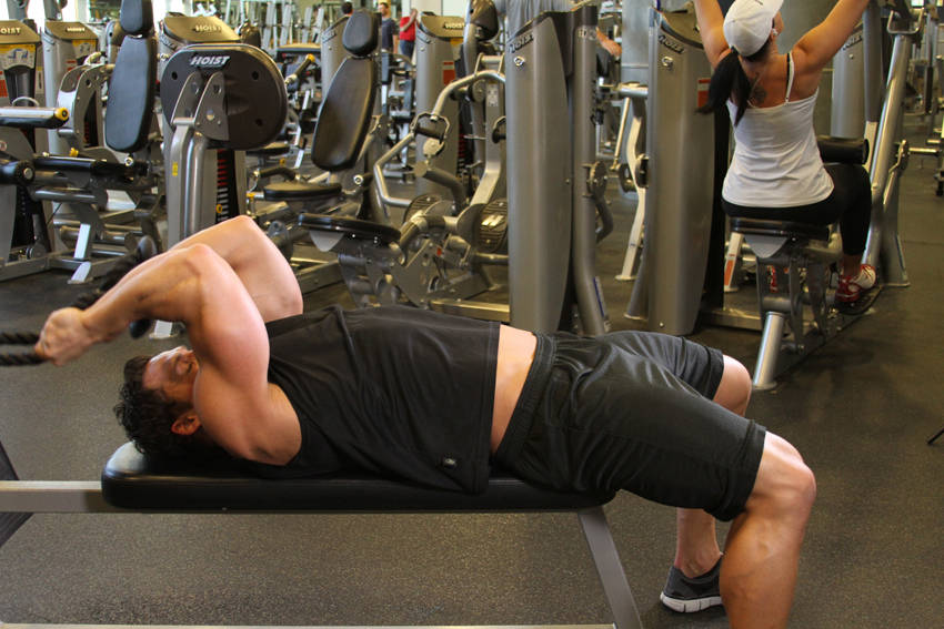 Demonstration of Low Cable Triceps Extension exercise showing proper form and technique