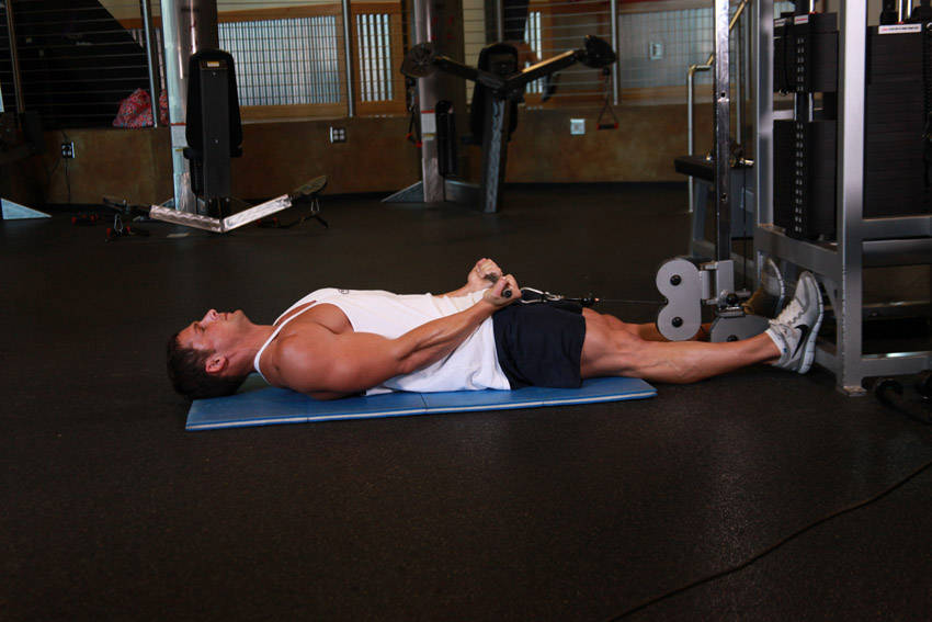 Demonstration of Lying Cable Curl exercise showing proper form and technique