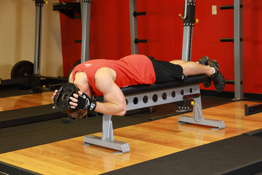 Demonstration of Lying Face Down Plate Neck Resistance exercise showing proper form and technique