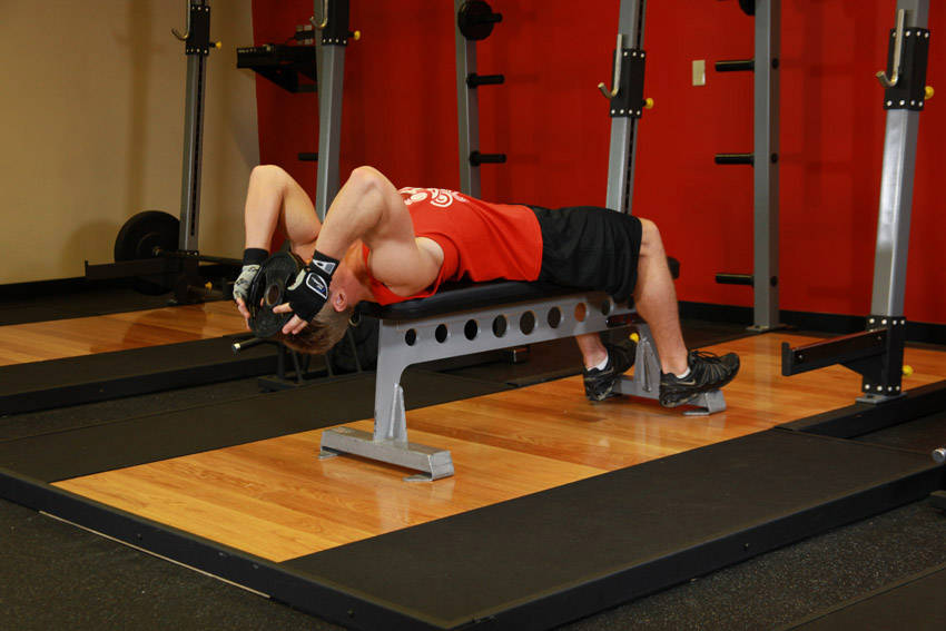 Demonstration of Lying Face Up Plate Neck Resistance exercise showing proper form and technique