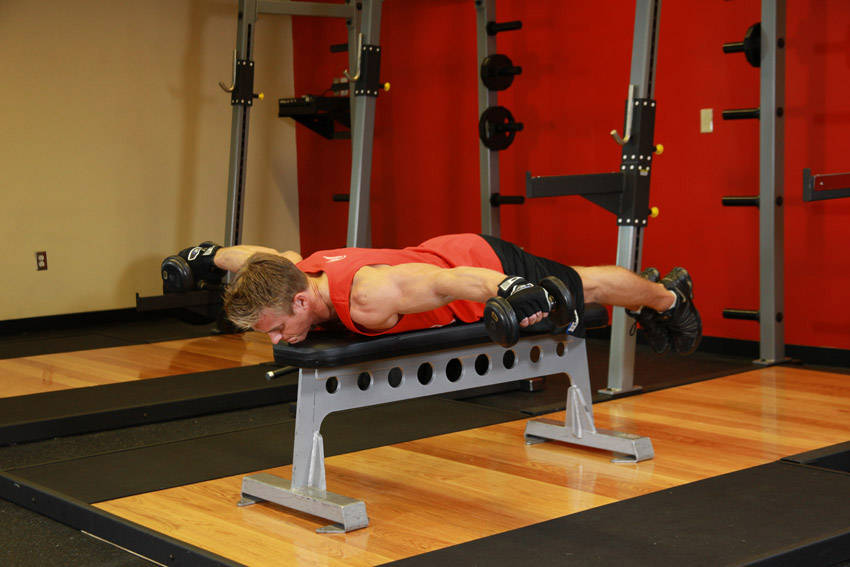 Demonstration of Lying Rear Delt Raise exercise showing proper form and technique