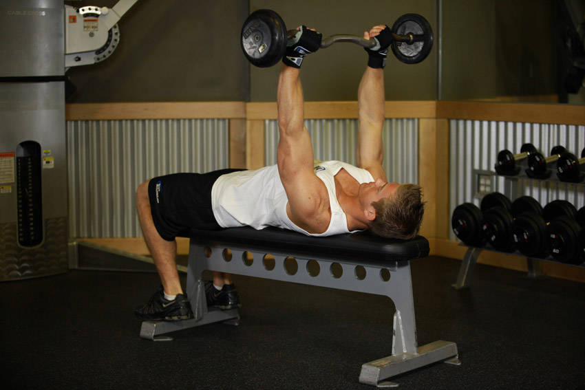 Demonstration of Lying Triceps Press exercise showing proper form and technique