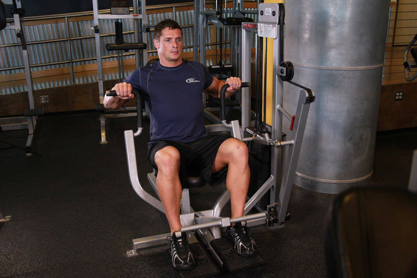 Demonstration of Machine Bench Press exercise showing proper form and technique
