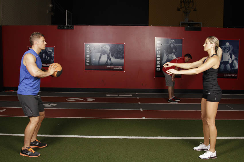 Demonstration of Medicine Ball Chest Pass exercise showing proper form and technique