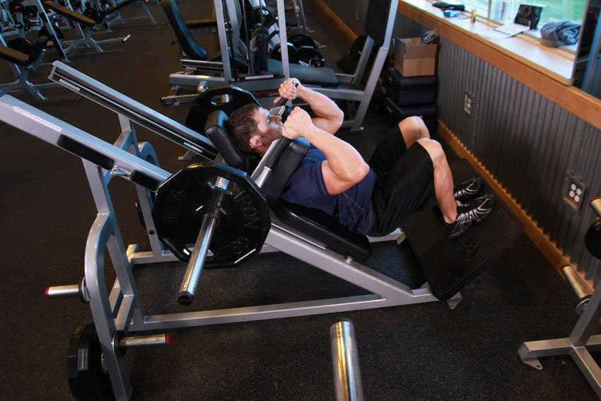 Demonstration of Narrow Stance Hack Squats exercise showing proper form and technique