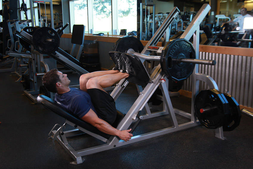 Demonstration of Narrow Stance Leg Press exercise showing proper form and technique