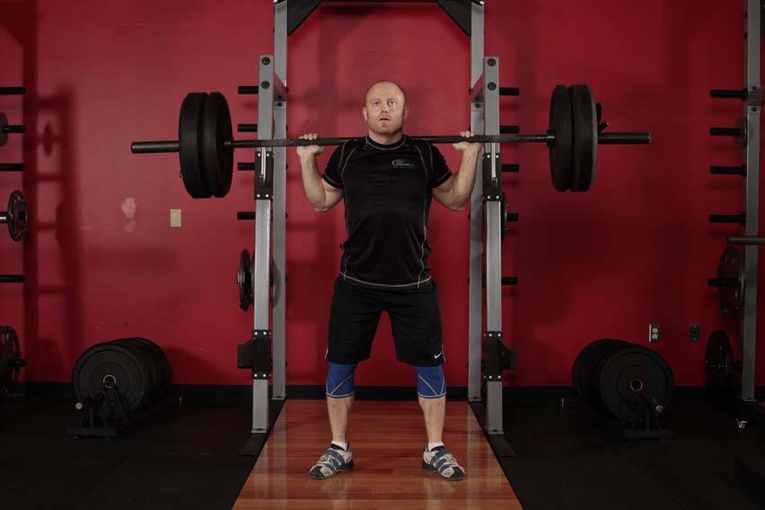 Demonstration of Olympic Squat exercise showing proper form and technique