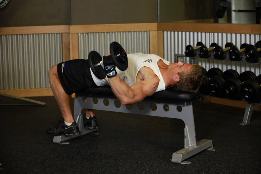 Demonstration of One-Arm Flat Bench Dumbbell Flye exercise showing proper form and technique