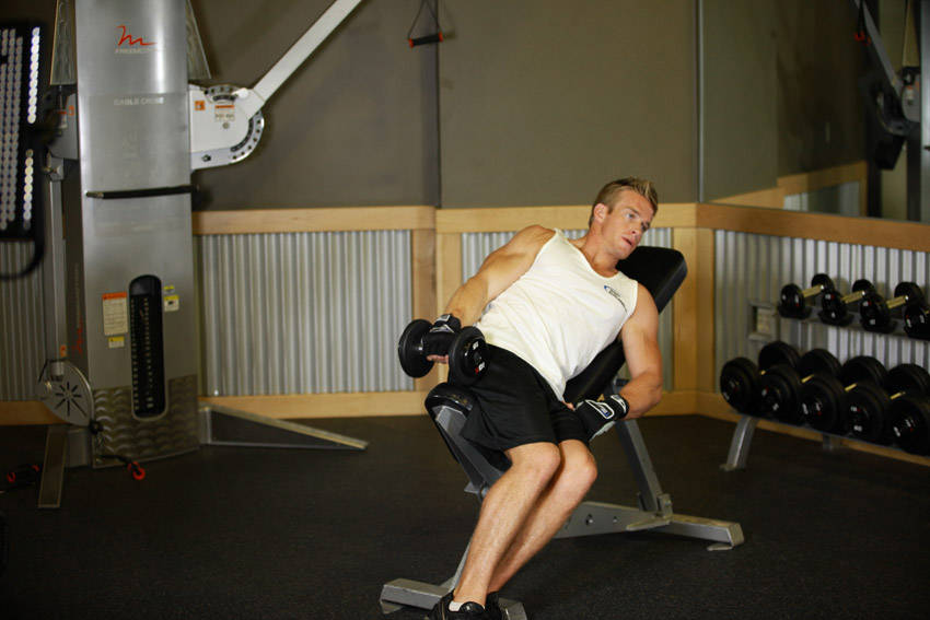 Demonstration of One-Arm Incline Lateral Raise exercise showing proper form and technique