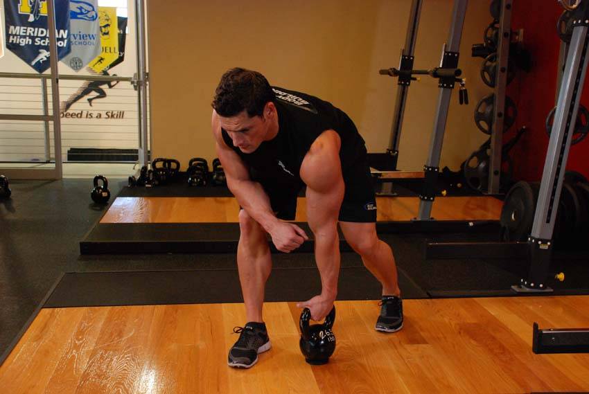 Demonstration of One-Arm Kettlebell Row exercise showing proper form and technique