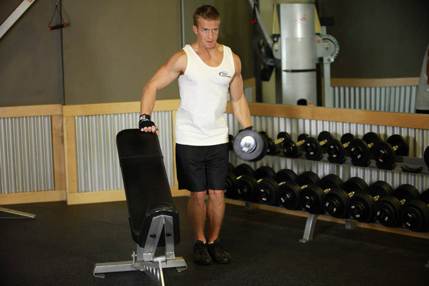 Demonstration of One-Arm Side Laterals exercise showing proper form and technique