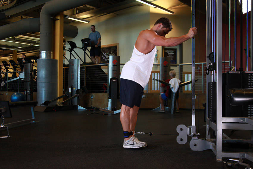 Demonstration of One-Legged Cable Kickback exercise showing proper form and technique