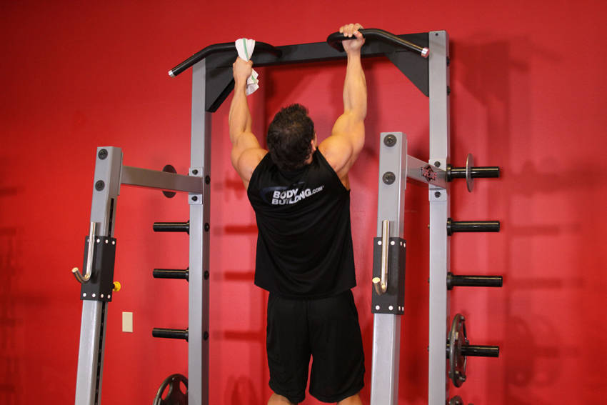 Demonstration of One Arm Chin-Up exercise showing proper form and technique