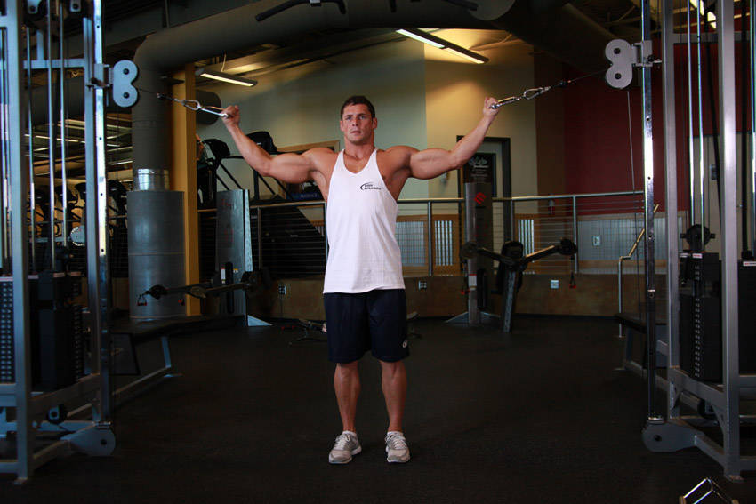Demonstration of Overhead Cable Curl exercise showing proper form and technique