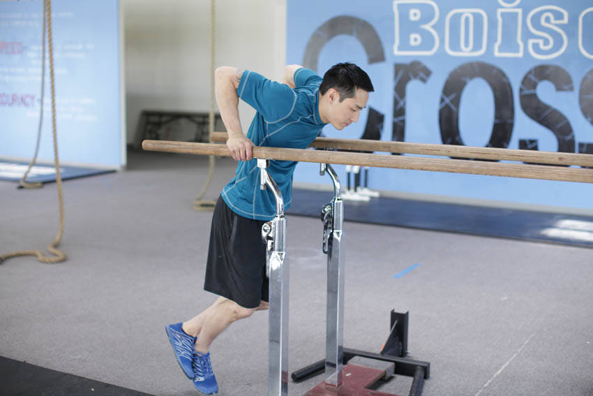 Demonstration of Parallel Bar Dip exercise showing proper form and technique