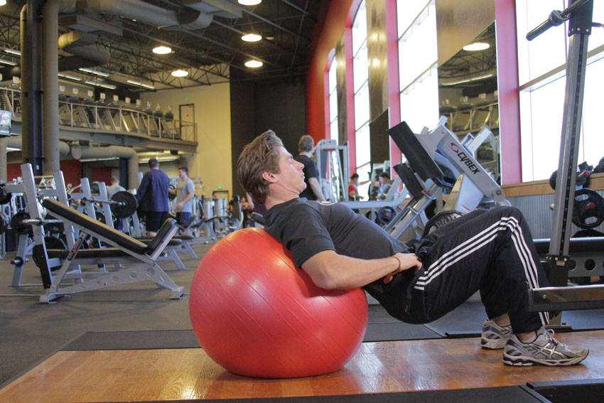 Demonstration of Physioball Hip Bridge exercise showing proper form and technique