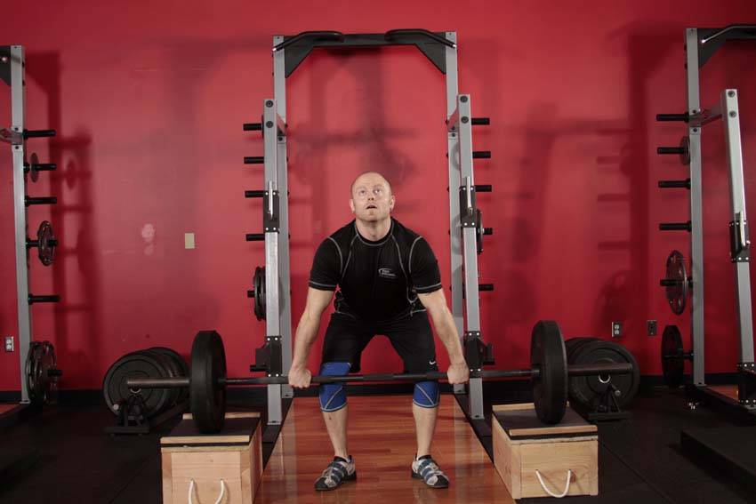 Demonstration of Power Clean from Blocks exercise showing proper form and technique