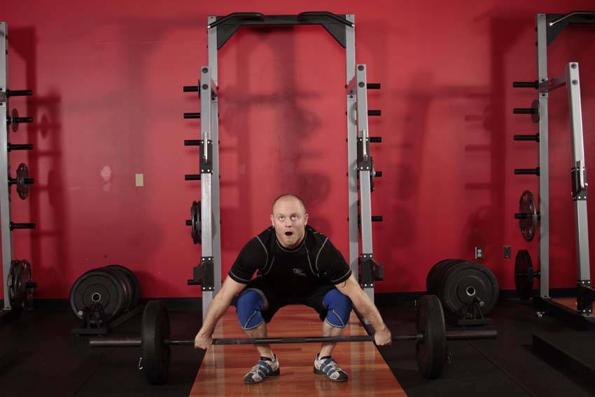 Demonstration of Power Snatch exercise showing proper form and technique