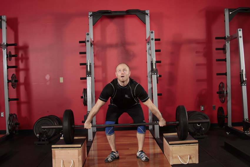 Demonstration of Power Snatch from Blocks exercise showing proper form and technique