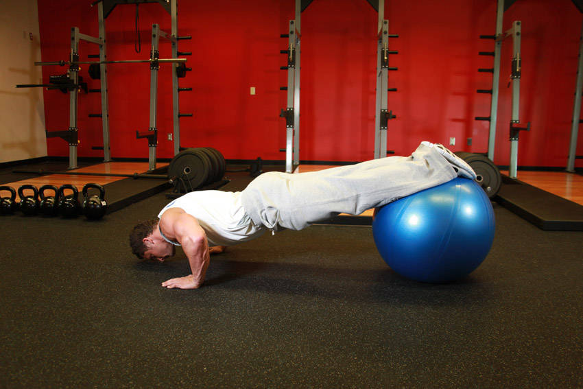 Demonstration of Push-Ups With Feet On An Exercise Ball exercise showing proper form and technique