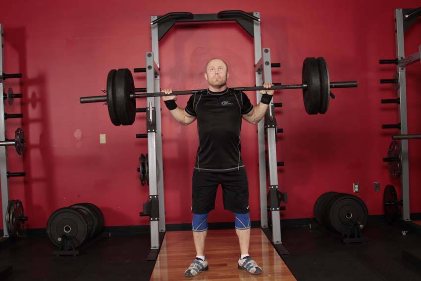 Demonstration of Push Press - Behind the Neck exercise showing proper form and technique