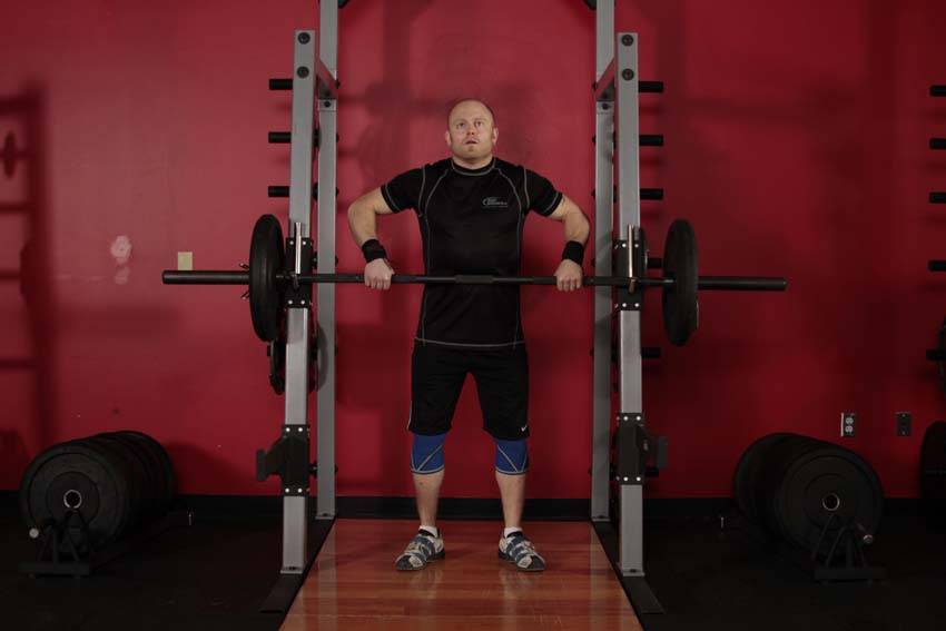 Demonstration of Rack Delivery exercise showing proper form and technique