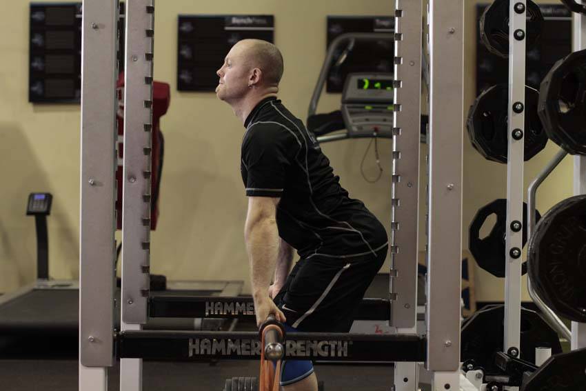 Demonstration of Rack Pull with Bands exercise showing proper form and technique