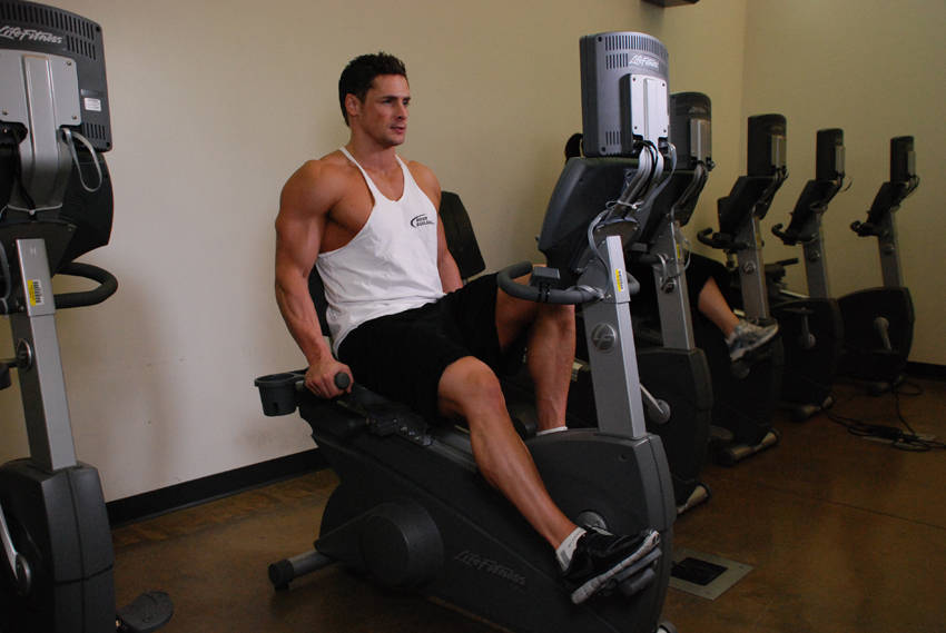 Demonstration of Recumbent Bike exercise showing proper form and technique