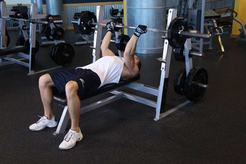 Demonstration of Reverse Triceps Bench Press exercise showing proper form and technique