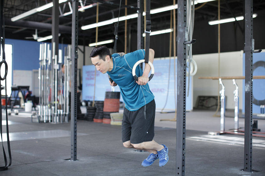 Demonstration of Ring Dips exercise showing proper form and technique