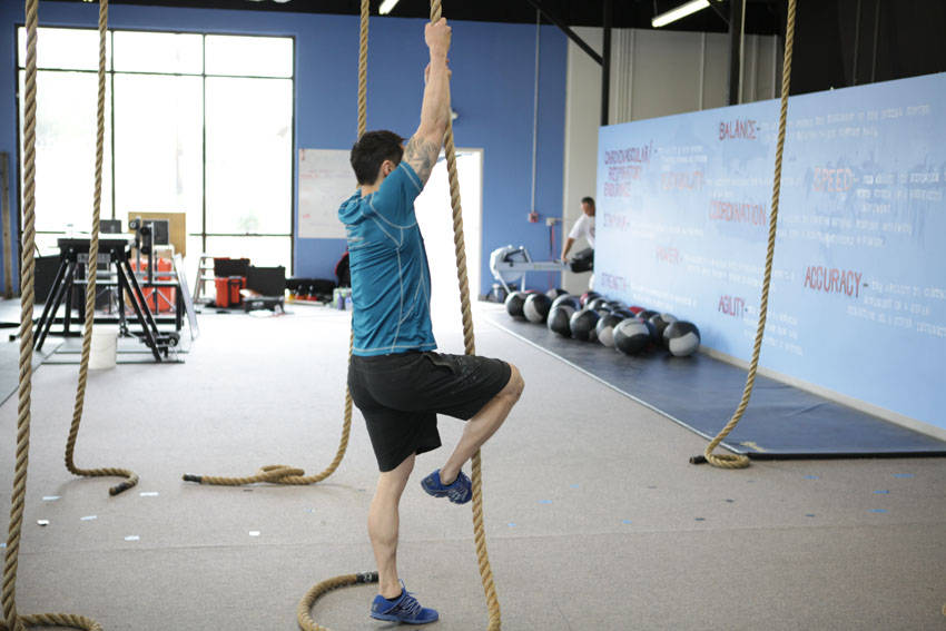 Demonstration of Rope Climb exercise showing proper form and technique