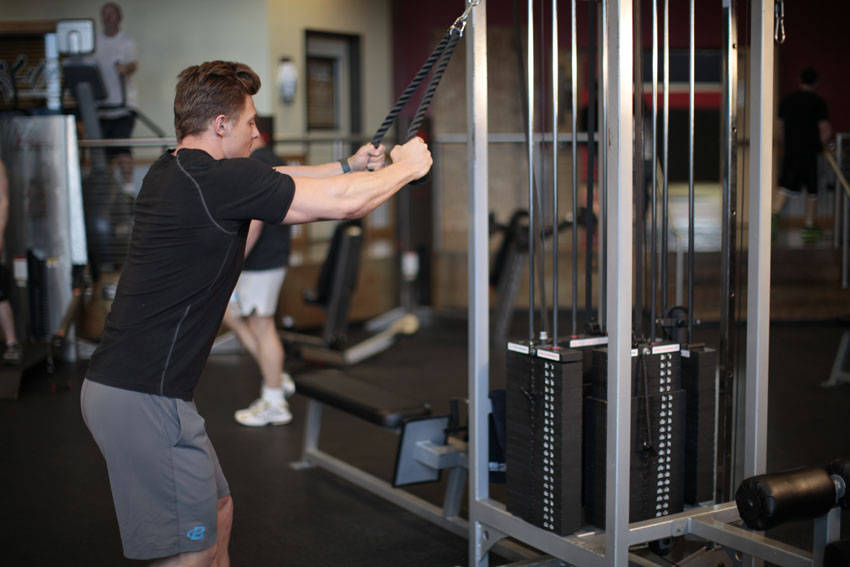 Demonstration of Rope Straight-Arm Pulldown exercise showing proper form and technique
