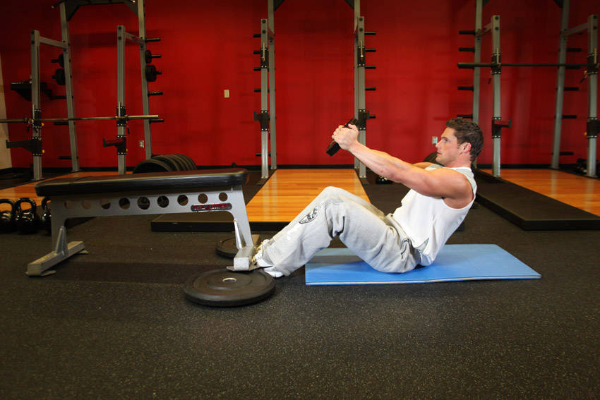 Demonstration of Russian Twist exercise showing proper form and technique
