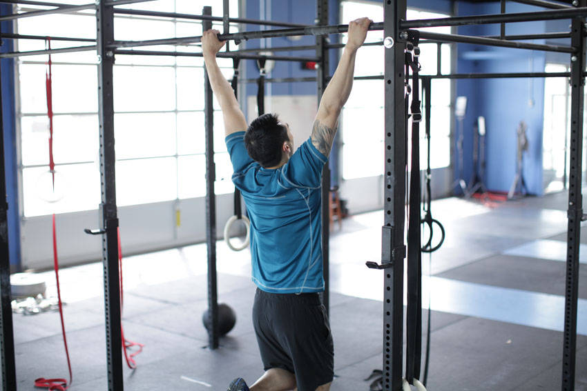 Demonstration of Scapular Pull-Up exercise showing proper form and technique