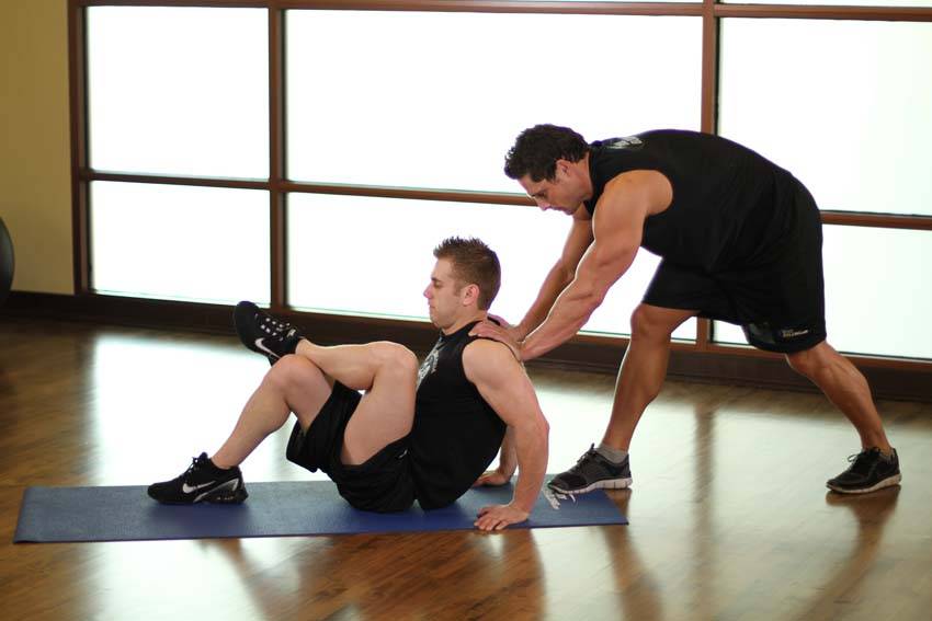 Demonstration of Seated Glute exercise showing proper form and technique
