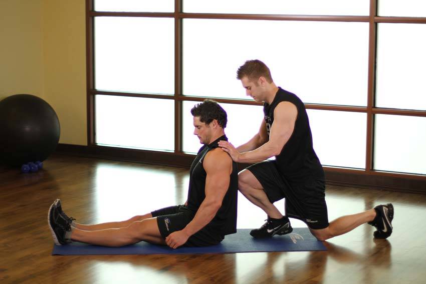 Demonstration of Seated Hamstring exercise showing proper form and technique