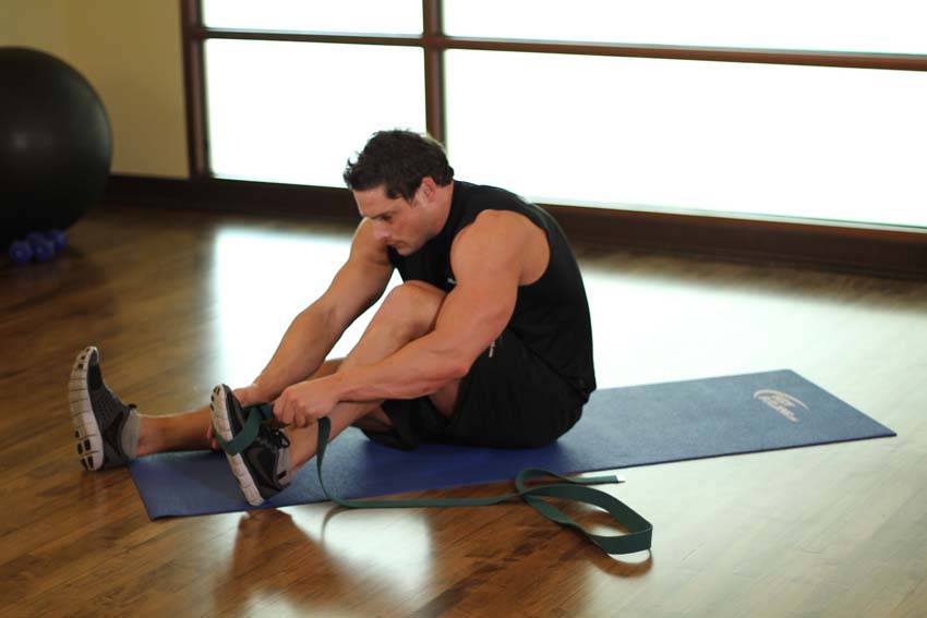 Demonstration of Seated Hamstring and Calf Stretch exercise showing proper form and technique