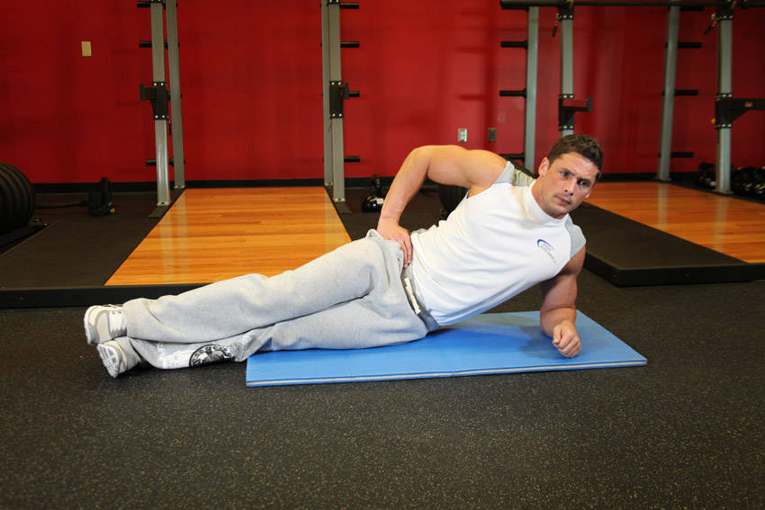 Demonstration of Side Bridge exercise showing proper form and technique
