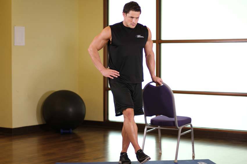 Demonstration of Side Leg Raises exercise showing proper form and technique