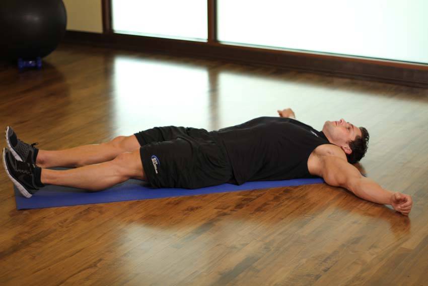Demonstration of Side Lying Groin Stretch exercise showing proper form and technique