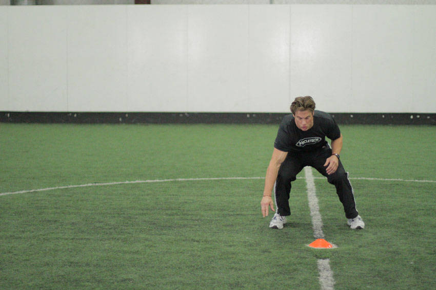 Demonstration of Side Standing Long Jump exercise showing proper form and technique