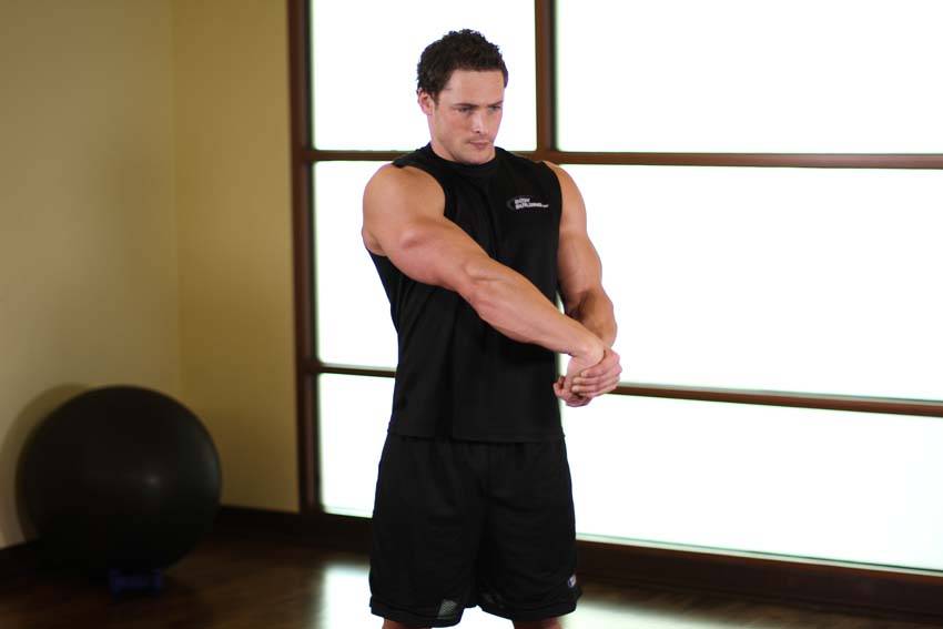 Demonstration of Side Wrist Pull exercise showing proper form and technique