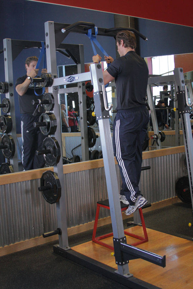 Demonstration of Single-Leg High Box Squat exercise showing proper form and technique
