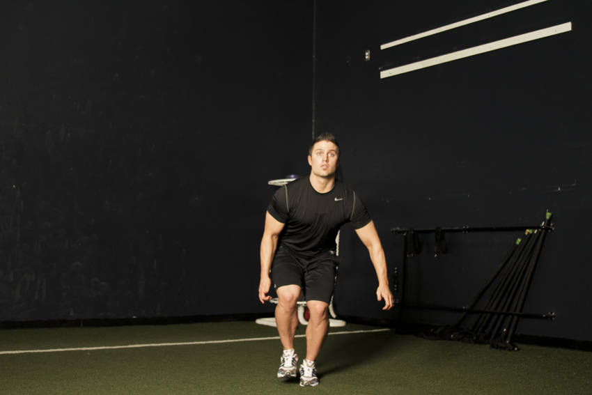 Demonstration of Single Leg Butt Kick exercise showing proper form and technique