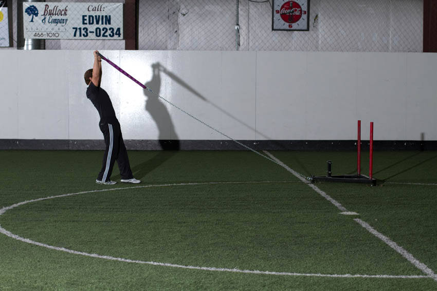 Demonstration of Sled Overhead Backward Walk exercise showing proper form and technique