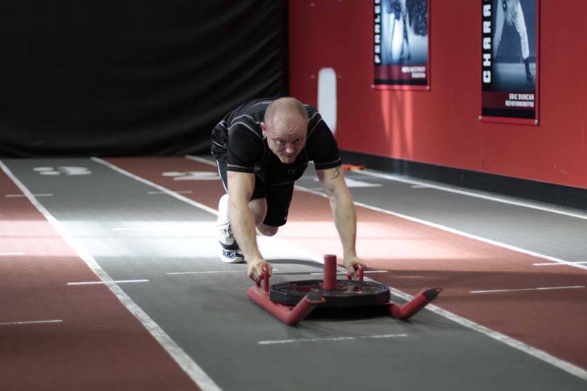 Demonstration of Sled Push exercise showing proper form and technique