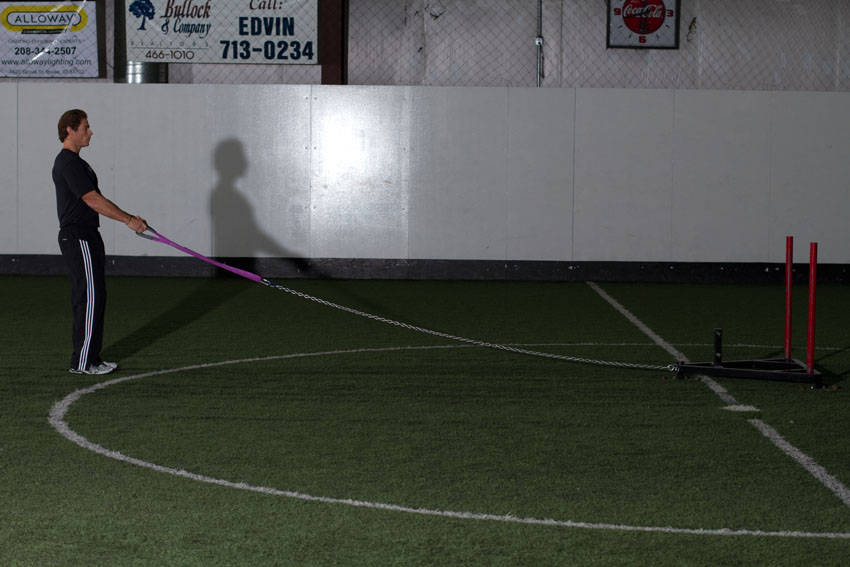 Demonstration of Sled Reverse Flye exercise showing proper form and technique