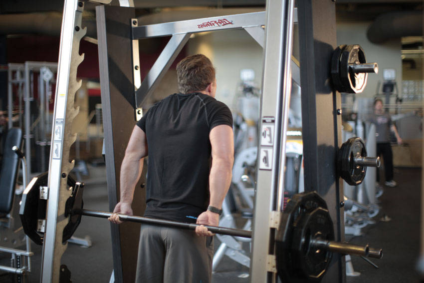Alternative demonstration of Smith Machine Behind the Back Shrug exercise
