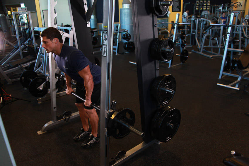 Demonstration of Smith Machine Bent Over Row exercise showing proper form and technique